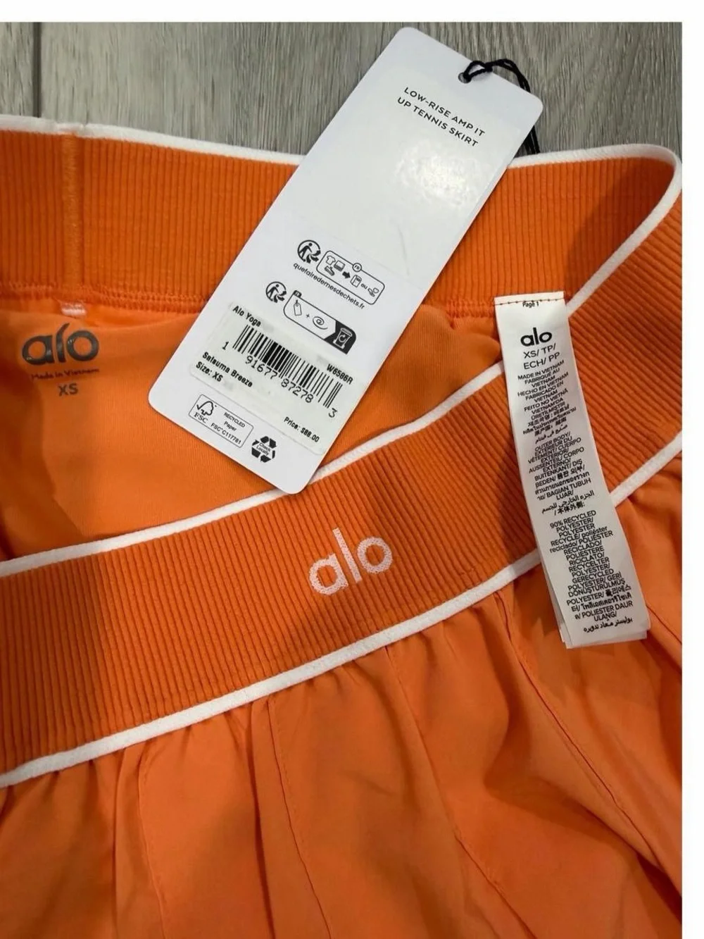 ALO Yoga Low Rise Amp It Up Tennis Skirt in Satsuma Breeze Orange.